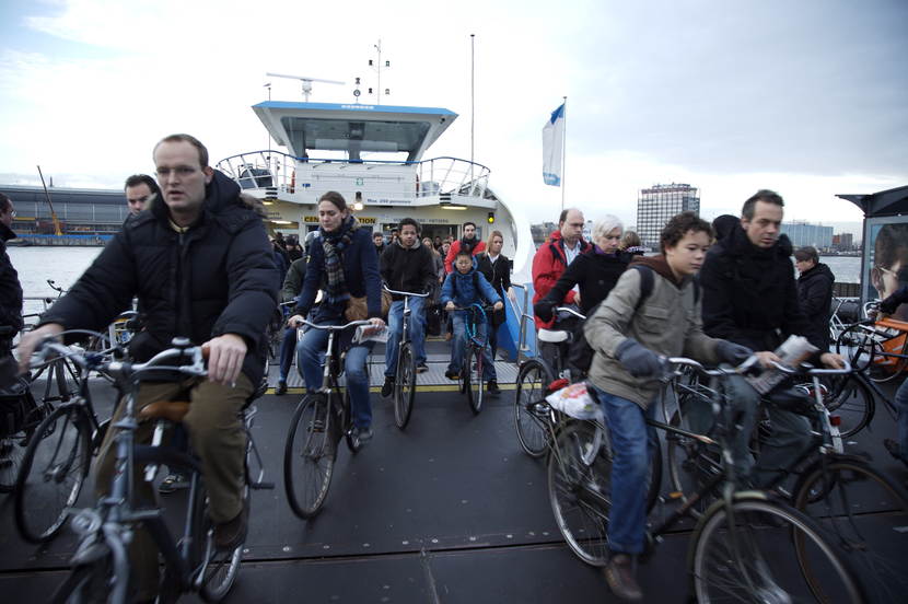 Cyclists leaving the IJ-ferry at Amsterdam Central Station during rush hour